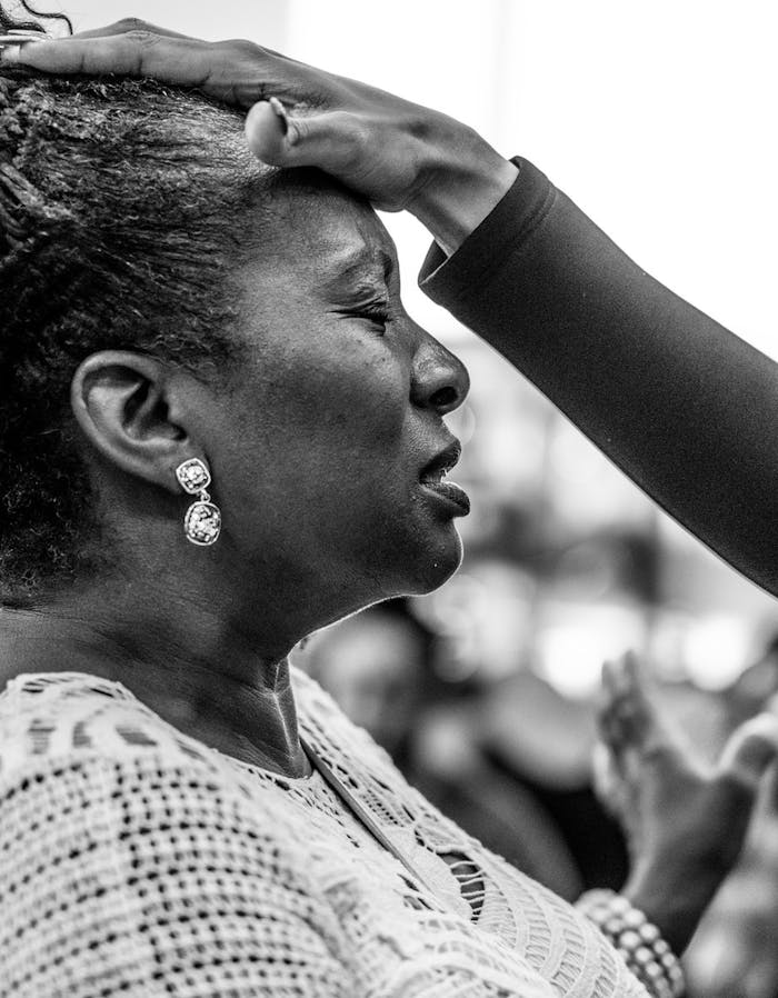 Side view of a woman with eyes closed, praying passionately.